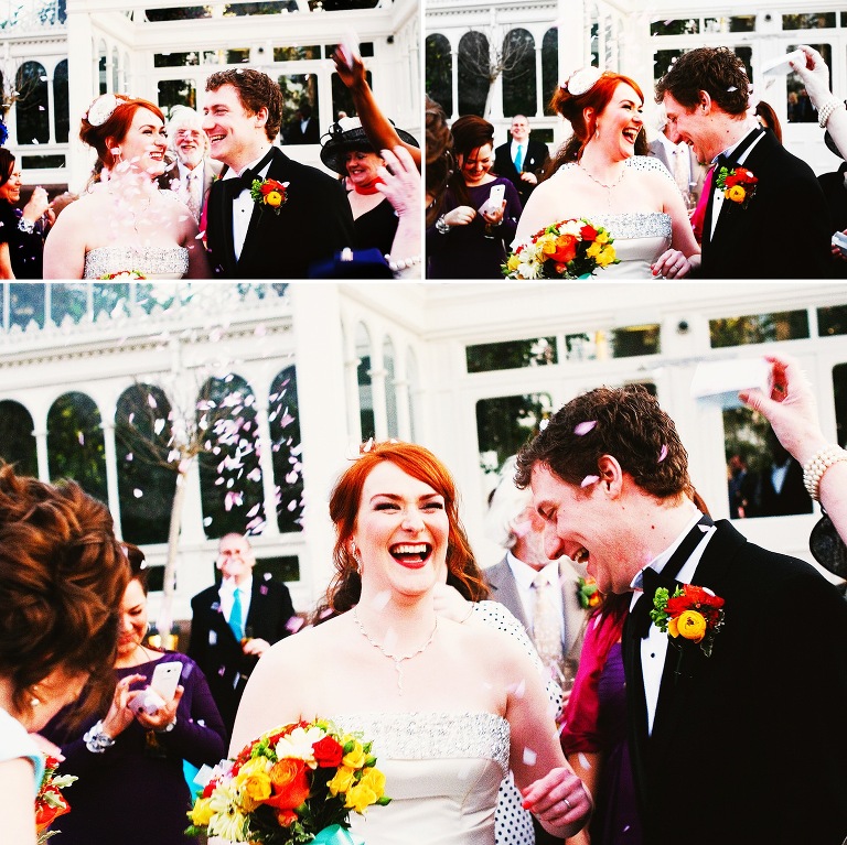Red-headed bride with her husband during the confetti throw at liverpools sefton park palm house.