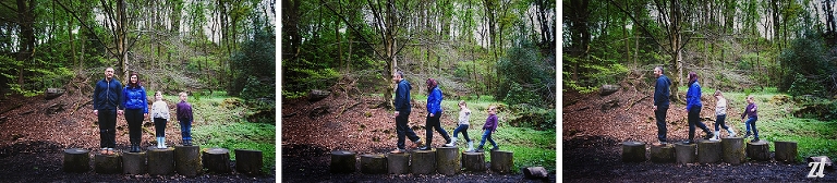 A family laughing on tree stumps in a Blackburn park