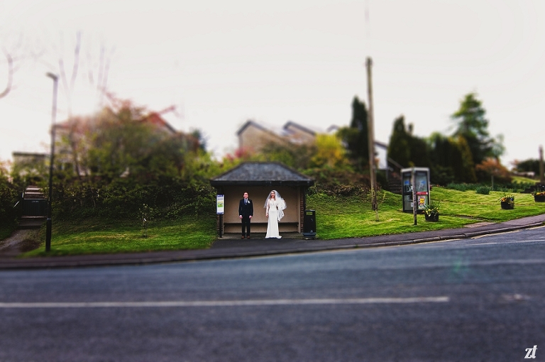Bride and groom stood outside a bus shelter at Shireburn Arms