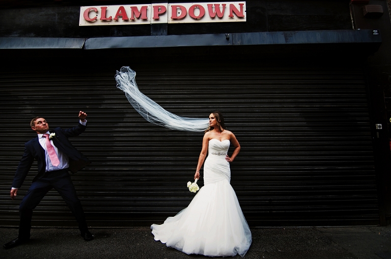 Creative wedding bride and groom in front of clampdown records in Manchester city centre