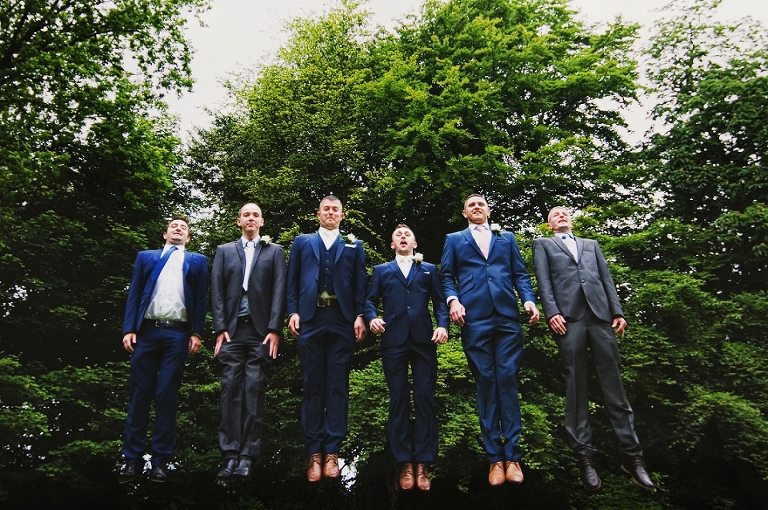 Groom and his groomsmen jumping at Ashfield House in Wigan