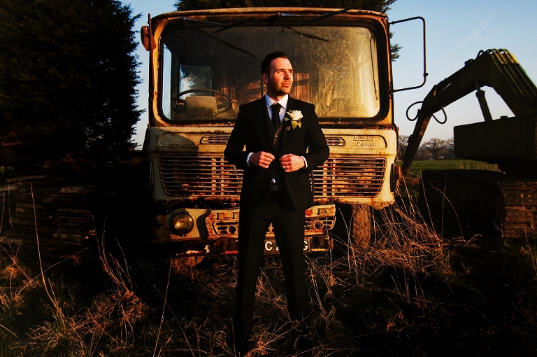 Groom standing in the sunset at Beeston Manor in Lancashire