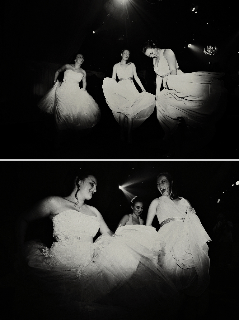 Black and white photo of bride and bridesmaids dancing at heaton House Farm in Cheshire