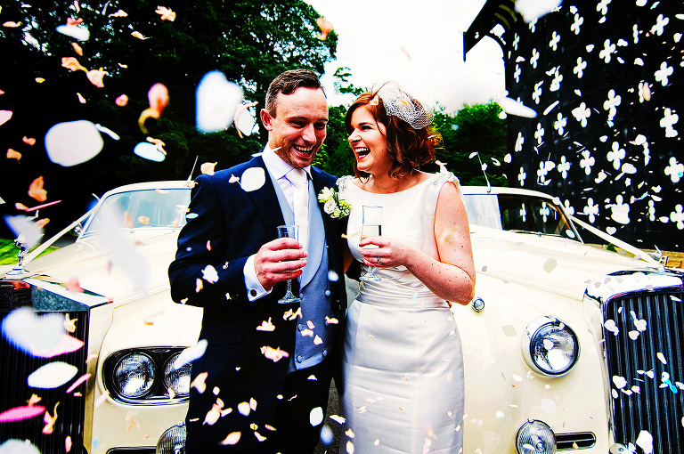 Colourful confetti photo with bride and groom at Samlesbury Hall.