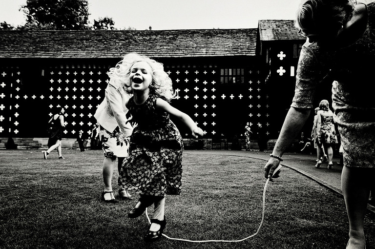 Young girl skipping at a samlesbury hall wedding.