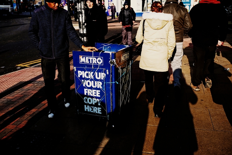 Street newspaper vendor in Manchester city centre