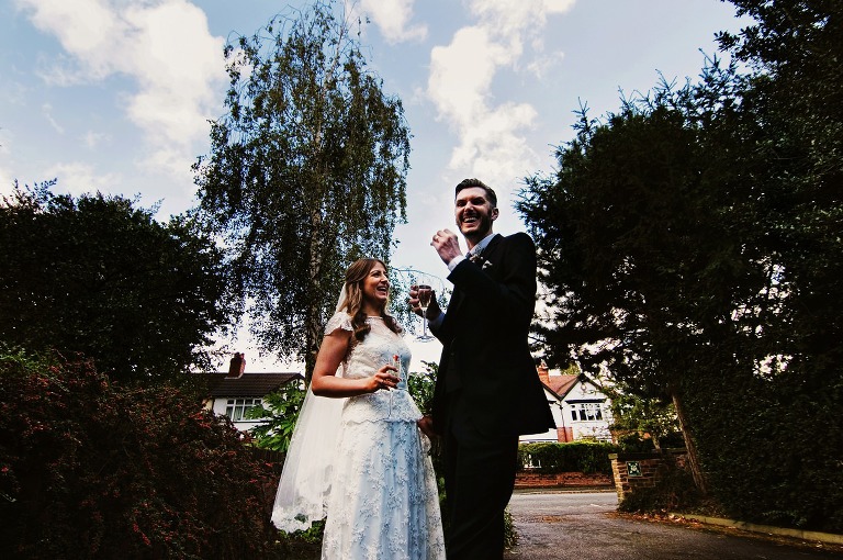 Bride and groom with champagne in Didsbury