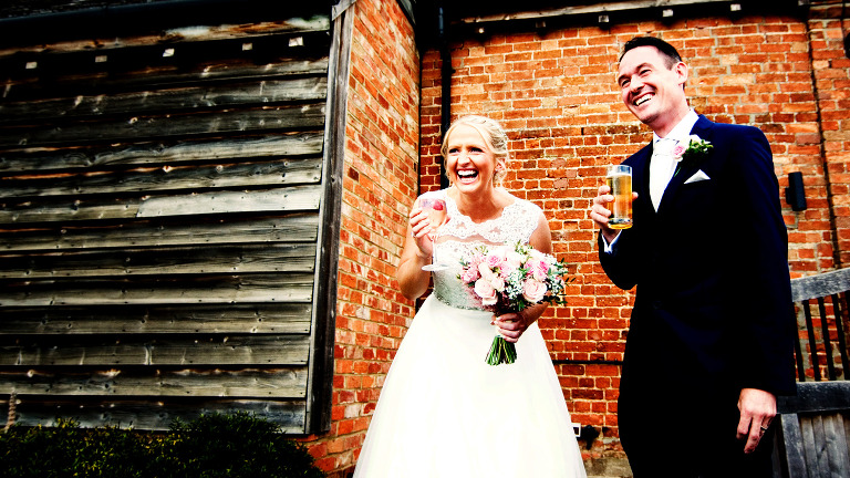 Bride and groom celebrating their wedding at Bassmead Manor Barns in St neots