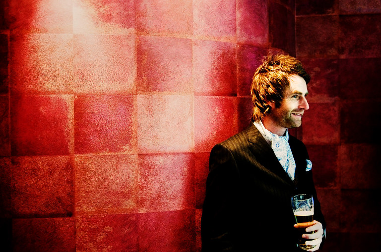 Groom having a pint at his wedding at Oddfellows in Chester