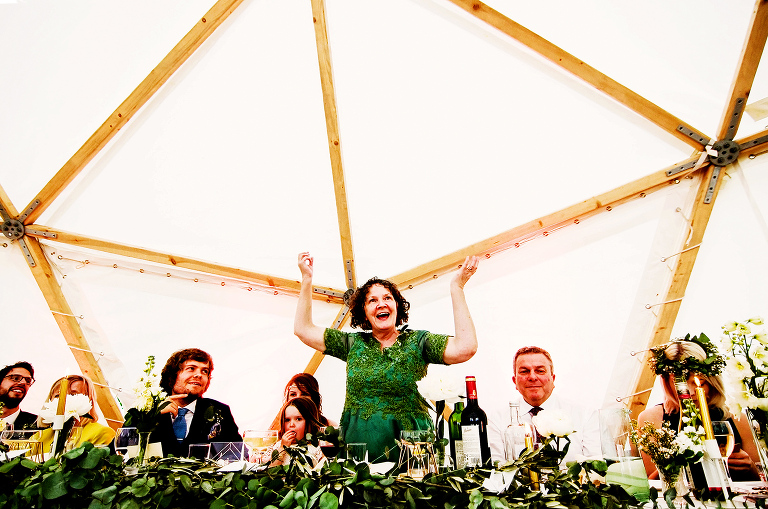 Mother of the bride doing her speech at this festival style wedding.