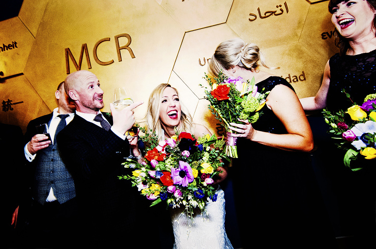 Bride and groom with their wedding party inside manchester hall.