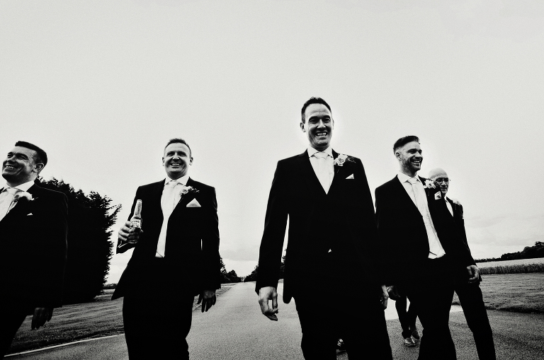 Groom and groomsmen with ushers