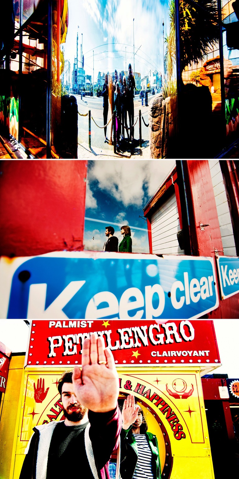 Bright and colourful couple shoot on pier in Blacklpool with keep clear sign and palmist pentulengro.