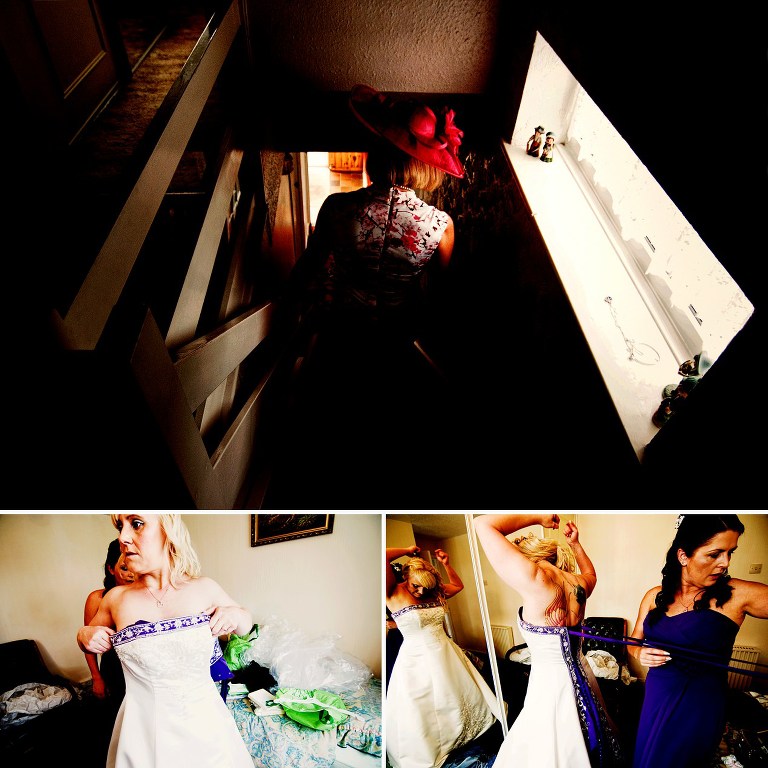 Bride putting on her purple inspired wedding dress with the help of her chief bridesmaid.