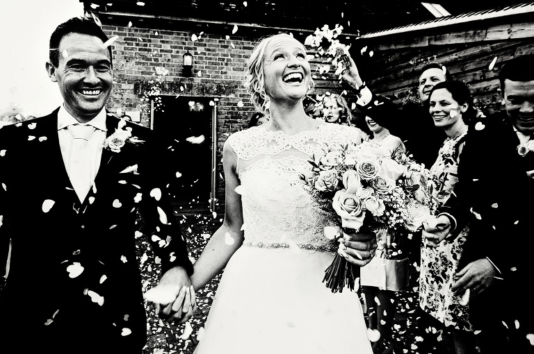 Confetti throwing over bride and groom at bassmead manor barns.
