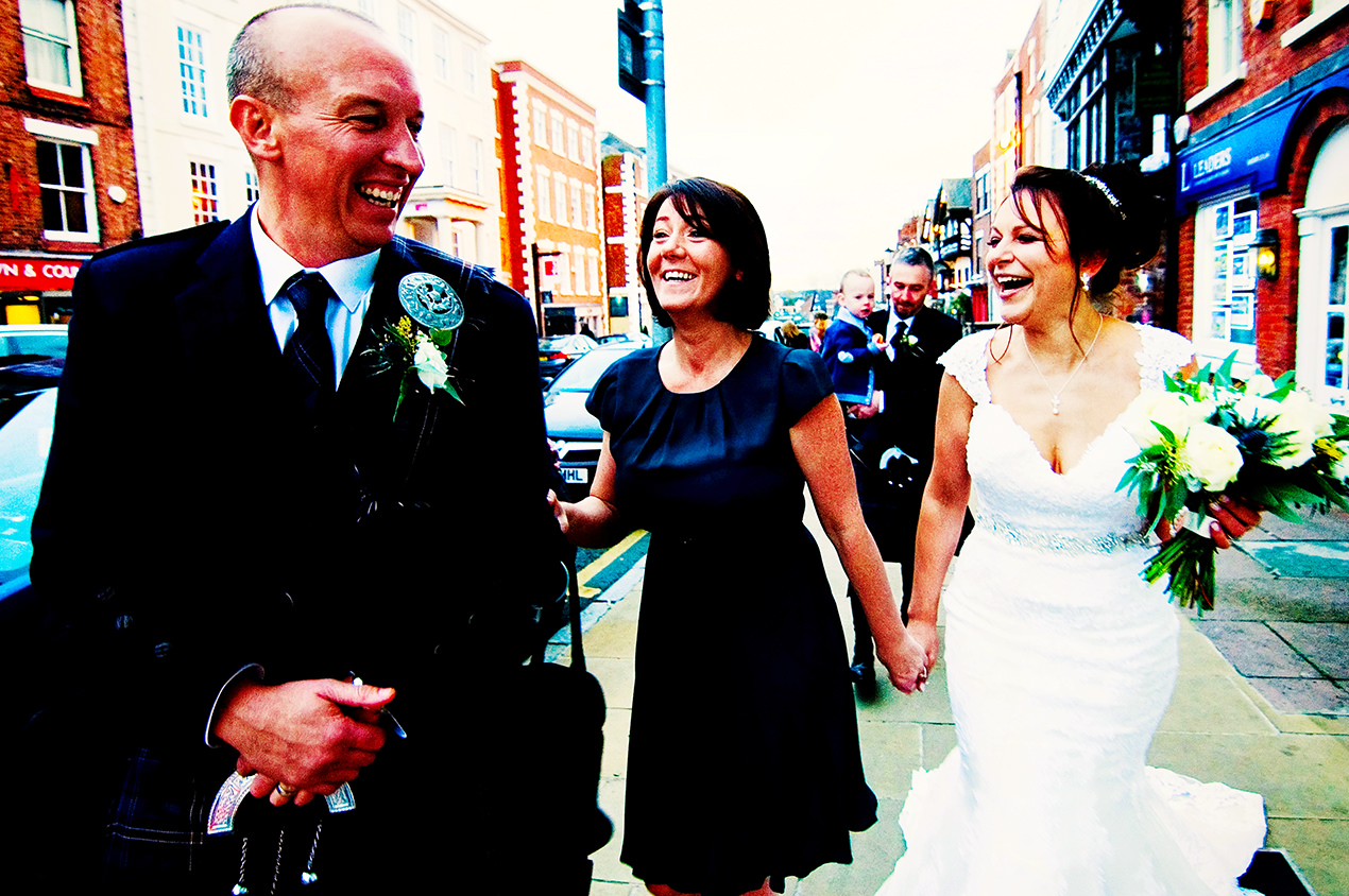 Just married bride and groom with family outside oddfellows in Chester.