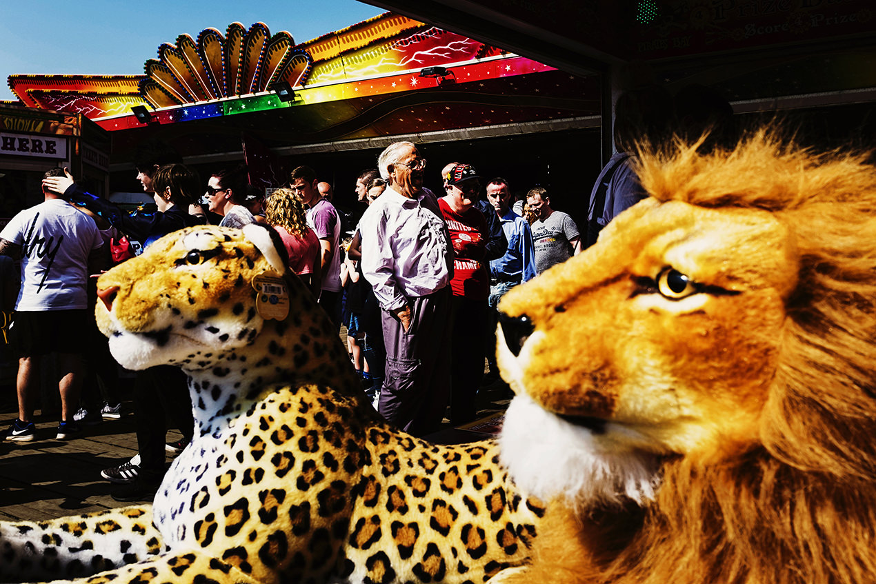 Holiday-makers and cuddly toys on central pier in blackpool.