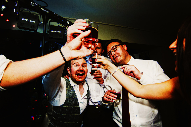 Drinking shots at a holdsworth house wedding.