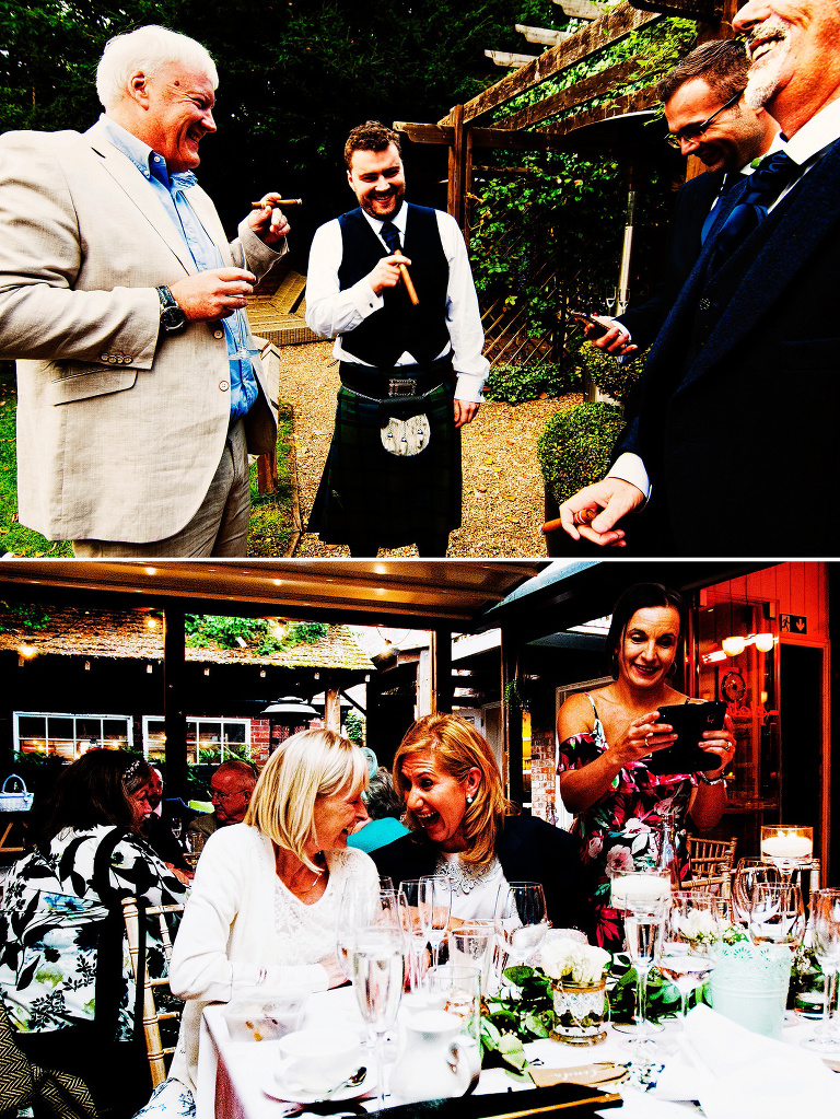 Groom wearing a tartan kilt smoking a cigar with groomsmen at outdoor summer wedding.