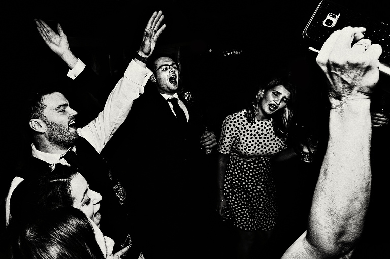 Black and white photo of guests dancing at a Manchester wedding.