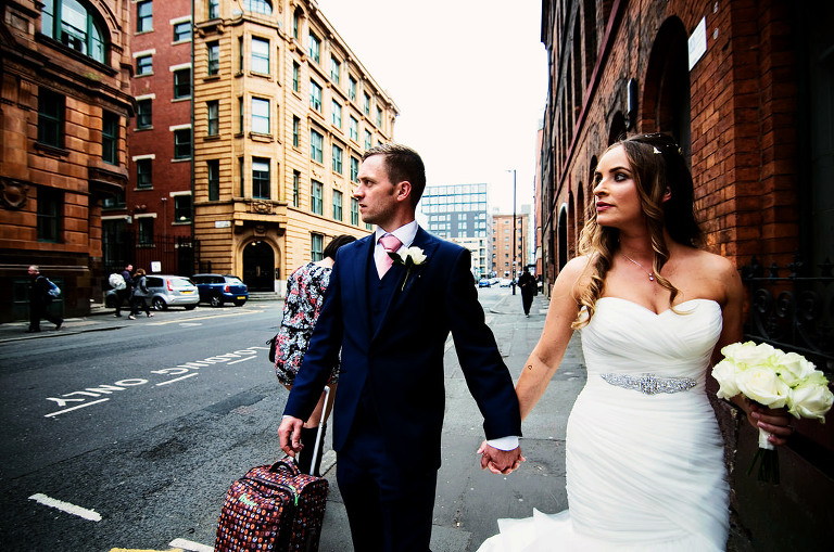 Bride and groom walking in the Northern Quarter of manchester on their wedding day